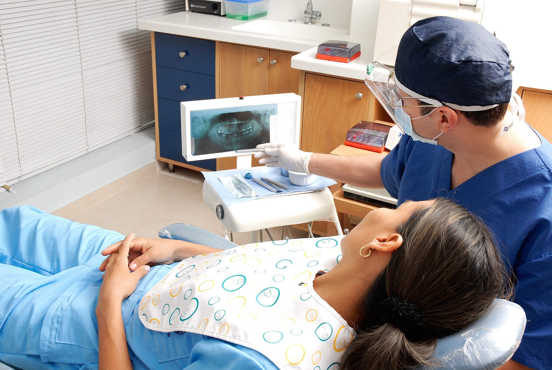 dentist reviewing X-rays with patient