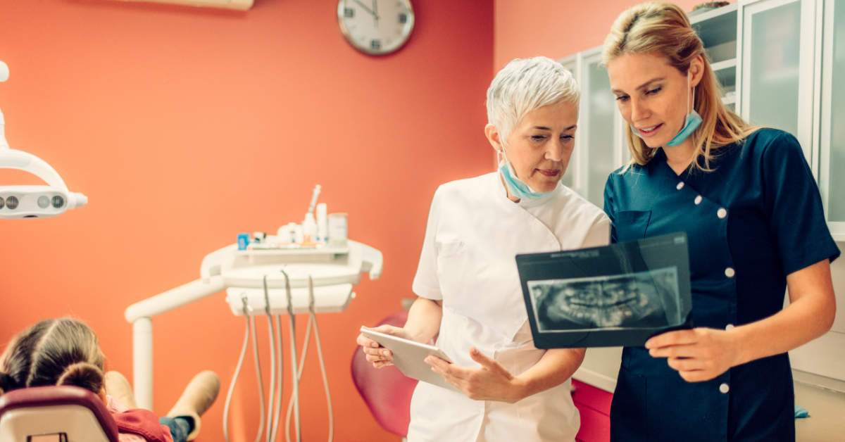 dentist reviewing X-rays with patient