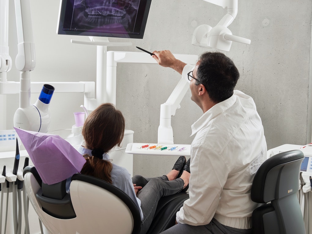 dentist reviewing X-rays with patient