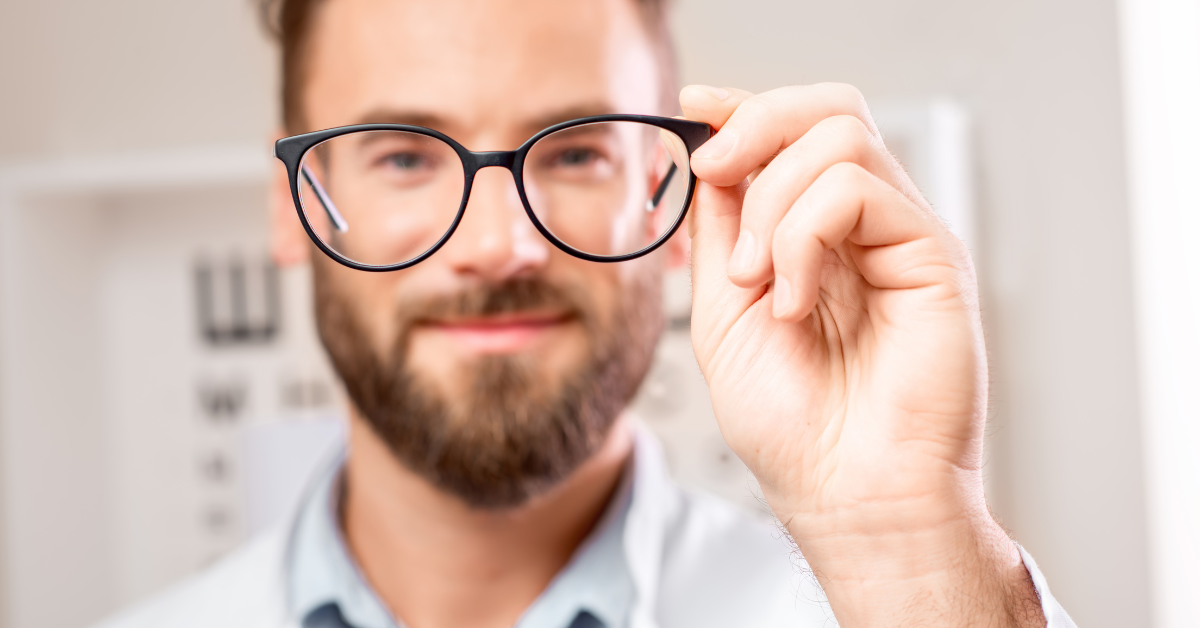 man holding up glasses