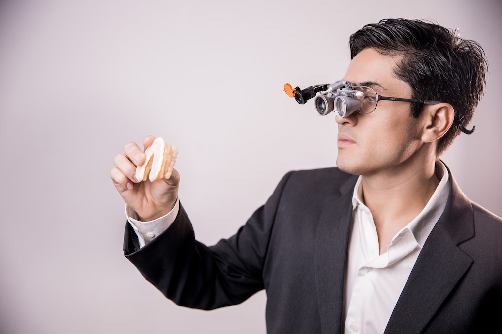 man examining dentures