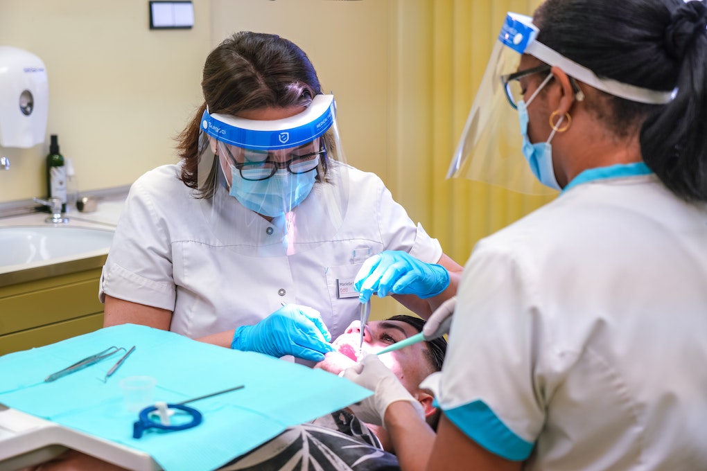 two dentists working on a patient