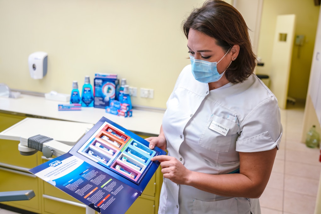 dentist holding electric toothbrushes