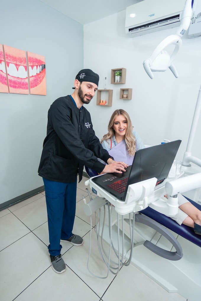 dentist showing patient computer