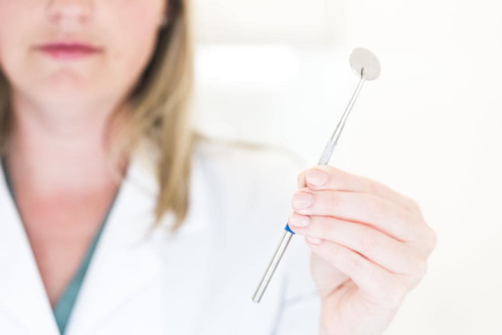 dentist holding a tool